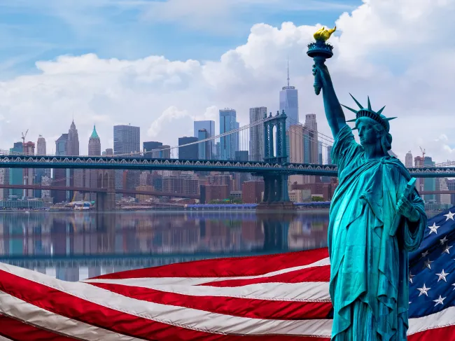 statue of liberty and american flag